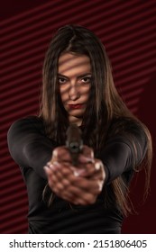 Beautiful Femme Fatale Hitwoman Holding A Gun