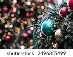 Beautiful festive decorations on the Christmas tree. Close-up. Beautiful Christmas background. The concept of decorations and decor for the new year. New Year