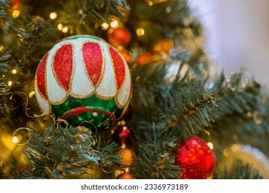 Beautiful festive decorations on the Christmas tree. Close-up. Beautiful Christmas background. The concept of decorations and decor for the new year. New Year's card 2024.