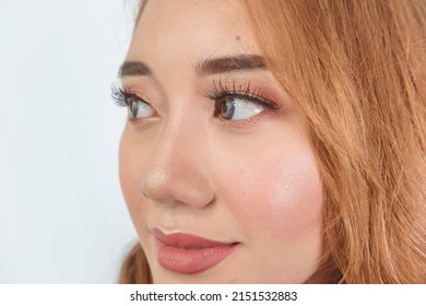 A Beautiful Filipina Model Showing The Results Of A Professional Makeup Session. Wearing Contact Lens And Sporting Brilliant Copper Dyed Hair.