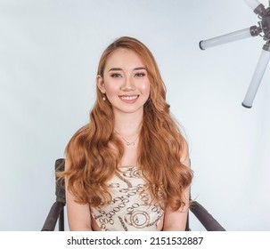 A beautiful Filipina model showing the results of a professional makeup session. Wearing contact lens and sporting brilliant copper dyed hair. - Shutterstock ID 2151532887