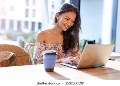 Beautiful Filipino woman using laptop at cafe
 - Shutterstock ID 1532800139