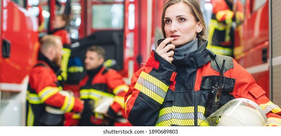 Beautiful Fire Fighter Woman With Her Helmet In Hand Standing In The Firehouse