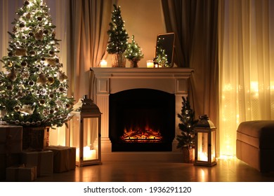 Beautiful fireplace, Christmas tree and other decorations in living room at night. Interior design