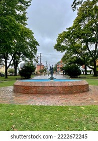 The Beautiful Fisherman Spear Fountain At Prescott Park. The Bronze Statue Is Of A Man With A Fish.