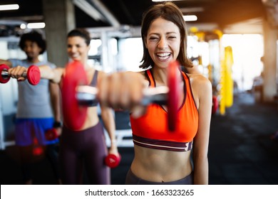 Beautiful Fit People Working Out In Gym Together