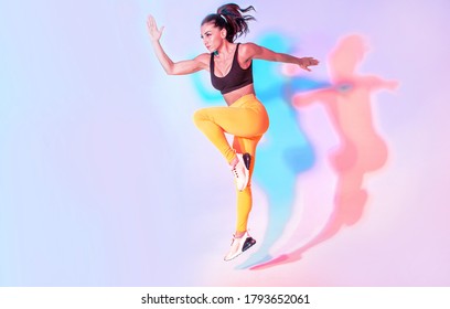 Beautiful Fit Woman Making Sport And Running. Studio Gel Lighting