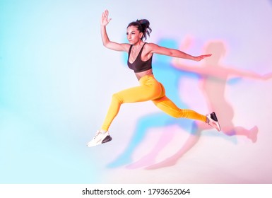 Beautiful Fit Woman Making Sport And Running. Studio Gel Lighting