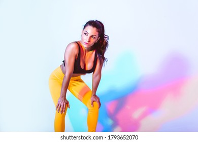 Beautiful Fit Woman Making Sport And Running. Studio Gel Lighting