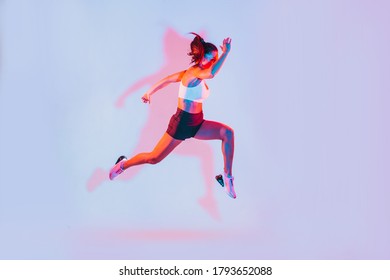 Beautiful Fit Woman Making Sport And Running. Studio Gel Lighting