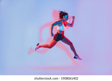 Beautiful Fit Woman Making Sport And Running. Studio Gel Lighting