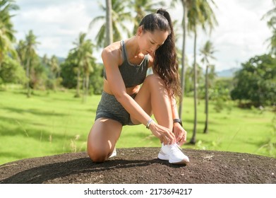 A Beautiful Fit Woman In Sportswear Tying Shoe Laces Get Ready For Exercising, Health And Sport Concept.