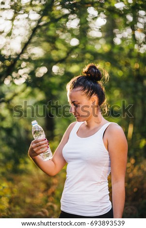 Beautiful Fitness Athlete Woman Drinking Water After Work Out
