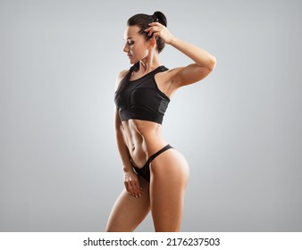 Beautiful Fitness Woman. Athletic Girl Posing On Background, Abs And Flat Belly