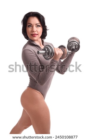 Beautiful fitness woman lifting dumbbells on a white background