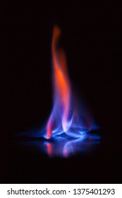 Beautiful flame of burning alcohol, great design for any purposes. Abstract blaze fire flame texture background. Gas flame. Black background.