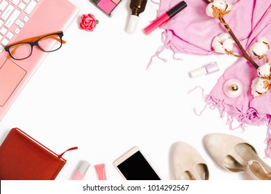 Beautiful flat lay arrangement with a laptop, glasses, cosmetics and other business and fashion feminine accessories. Mockup, white background, copyspace