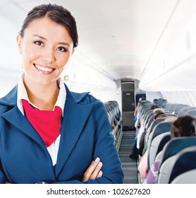 Beautiful Flight Attendant In An Airplane Smiling