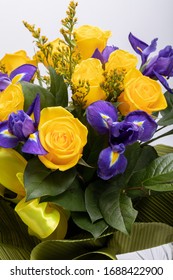 beautiful floristic bouquet of blue irises and yellow roses