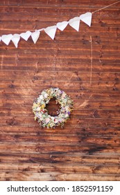 Beautiful Flower Wreath As A Decoration On A Wooden Barn Door