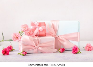 Beautiful flowers and gift boxes on light background - Powered by Shutterstock