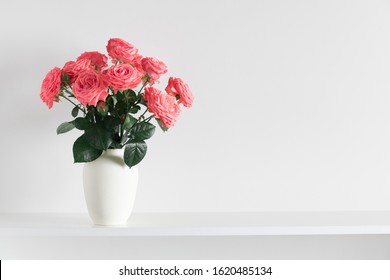 Beautiful flowers, pink roses. Roses in vase on shelf against white wall. Valentines Day, Easter, Happy Women's Day, Mother's day. Space for text. - Powered by Shutterstock