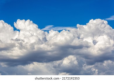 Beautiful fluffy white clouds in dramatic cloudscapes. Blue sky with contrasting puffy clouds. Monsoon clouds in the sky over the Sonoran Desert in Tucson, Arizona, USA.