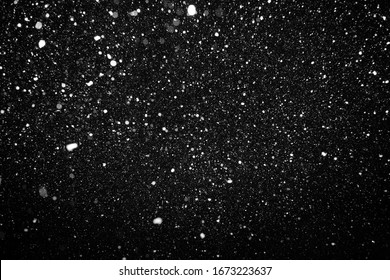 beautiful flying heavy snow on a black background of the night sky