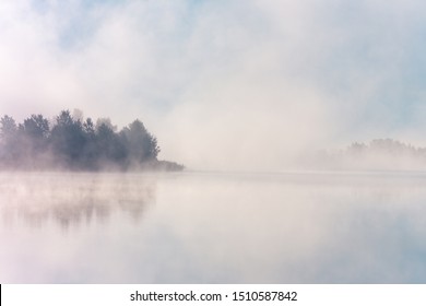 Beautiful foggy morning. Misty lake coast. Fog over autumn lake water.  - Powered by Shutterstock