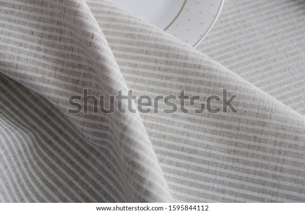 beautiful folds of light fabric,\
striped fabric made from natural fibers, eco-friendly\
fabric.