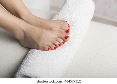 Beautiful Foot With Gel Red Pedicure On White Towel Roll