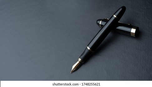 
Beautiful fountain pen. under exposed photo on a black background. - Shutterstock ID 1748255621