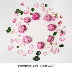 Beautiful frame made of pink roses on white background