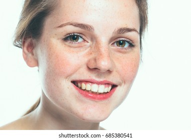Beautiful freckled face woman close up, healthy skin beauty girl model.