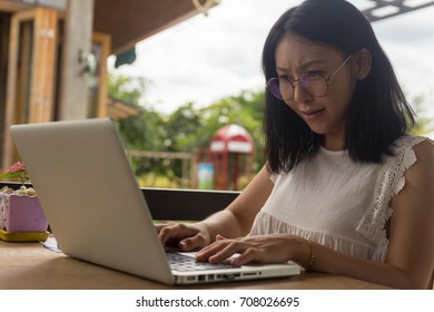 beautiful freelance businesswoman working on her laptop while sitting at the desk - Shutterstock ID 708026695