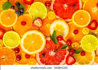 Beautiful Fresh Sliced Mixed Citrus Fruits As Background With Different Berries, Concept Of Healthy Eating, Dieting, Top Down