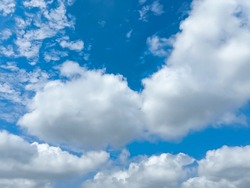 Beautiful Full Clouds On Blue Sky Background. Elegant Rainy White Clouds In Daylight. Big Soft White Fluffy Clouds Covered The Blue Sky. Cumulus Clouds Against Deep Blue Sky. Sunny Day. No Focus