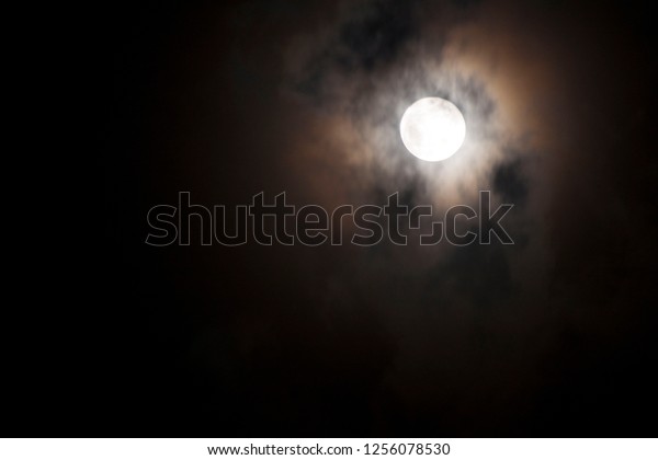 A beautiful full moon in a dark moon night, a\
bloody blood moon that looks frightening, a scary atmosphere on a\
stormy night and cloudy nights make the moon shine prominently in\
the sky, but scary.