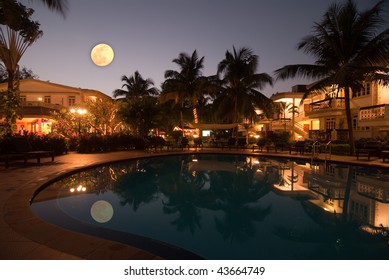 A beautiful full moon over a tropical resort - Powered by Shutterstock