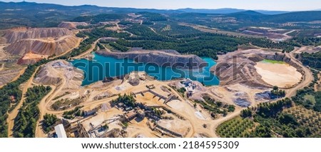 Beautiful full panoramic aerial view of an open-pit mine in Greece. Forests and mountains on the horizon. High quality photo