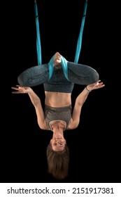 Beautiful Funny Young Woman Yoga Instructor Practicing Fly Yoga On Black Background. Vertical Frame. Aerial Anti-gravity Yoga