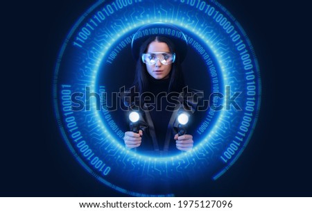 Beautiful gamer girl with controllers in hands. Woman in glasses of virtual reality. Augmented reality game, future technology, AI concept. Holographic interface.
