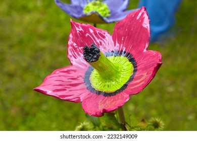 Beautiful garden decoration, a flower replica made of ceramic, (pink hibiscus replica). - Shutterstock ID 2232149009