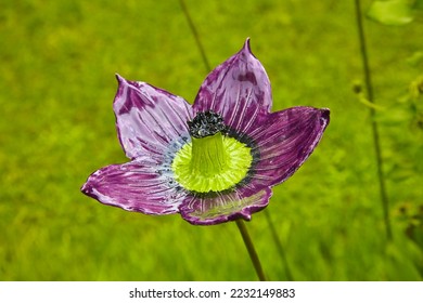 Beautiful garden decoration, a flower replica made of ceramic, (violet hibiscus replica). - Shutterstock ID 2232149883