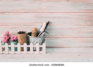 Beautiful Garden Flowers And Gardening Tools On  Shabby Chic Background