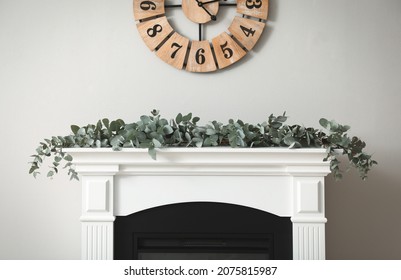 Beautiful Garland With Eucalyptus Branches On Mantelpiece In Room