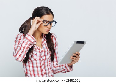 Beautiful Geek Woman Holding Digital Tablet In Studio On White