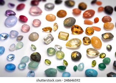 Beautiful gems background. Many real colorful gemstones: citrine, amethyst, topaz, ruby, emerald, prehnite, rose quartz, moonstones, tiger eye, labradorite, peridot and many more.