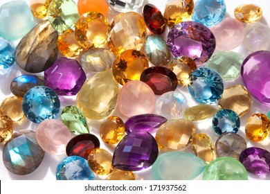Beautiful gems background. Photo of a sparkling and colorful real gemstones in natural sunlight.