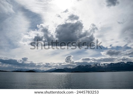 Beautiful giant cloud over the Beagle Channel. Beautiful cloud in the sky lit from behind by the sun. Religious image that inspires peace and tranquility. 